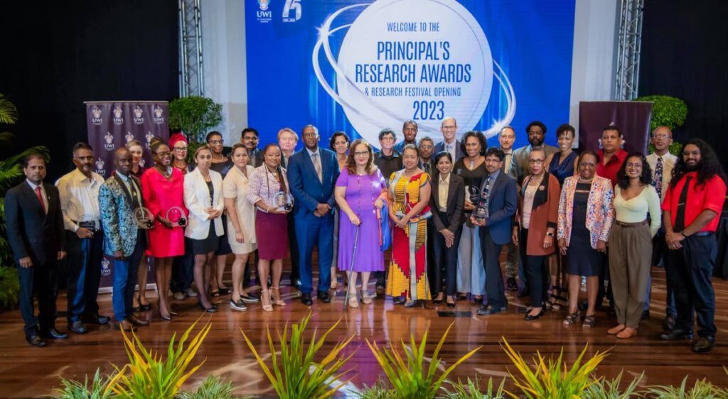 Pro Vice-Chancellor and Campus Principal Professor Rose-Marie Belle Antoine, front row centre, celebrates all awardees with Chief Justice Justice Ivor Archie, left, and Minister of Public Administration, right, Sen Allyson West at the UWI Principal's Research Awards.
 - 