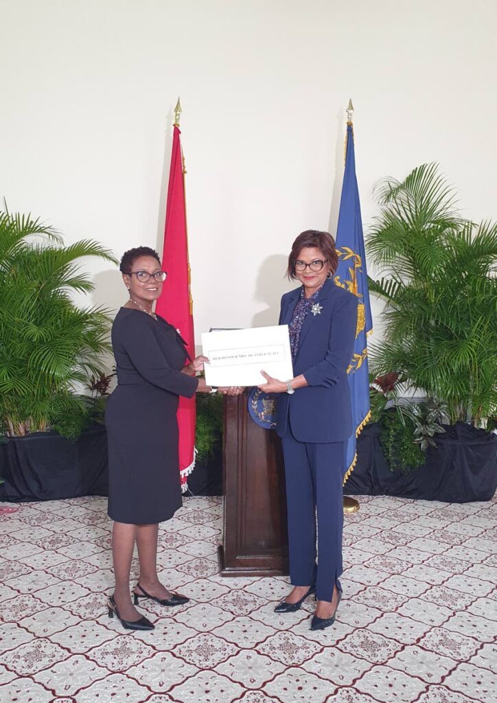 New president of the Industrial Court Heather Seale, left, receives her instrument of appointment from President Christine Kangaloo at President's House on December 13. - Photo courtesy Office of the President
