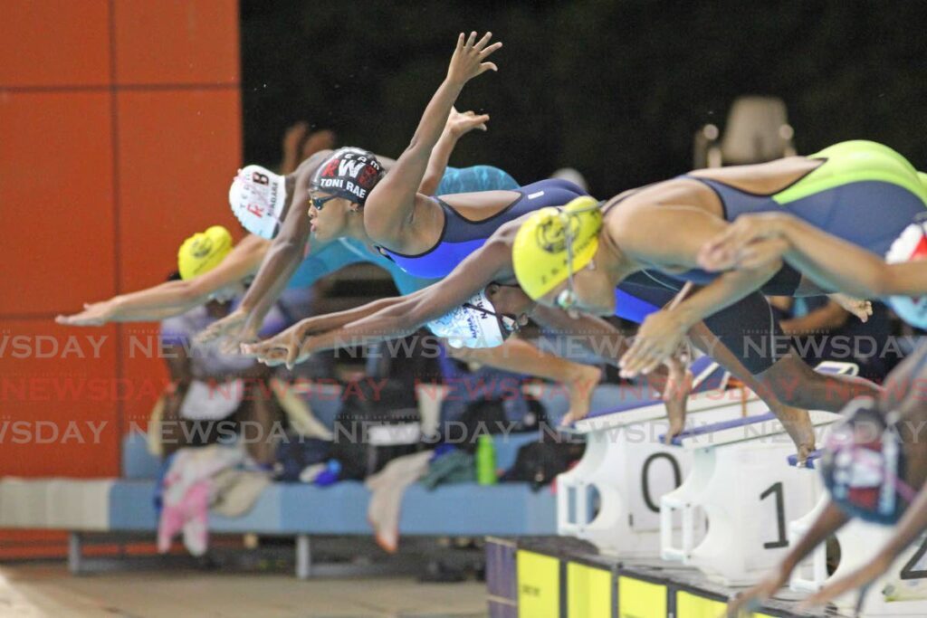 Participants hit the water in the Girls 11 and over 400m individual medley event in the ASATT Invitational Swimming Championships, at the National Aquatic Centre, Couva, Wednesday. - Photo by Lincoln Holder 