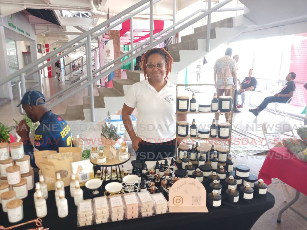 Owner of Modest Sensaations, Partiena Modeste at her booth at the National Christmas Craft Market on Friday. - Photo by Joey Bartlett