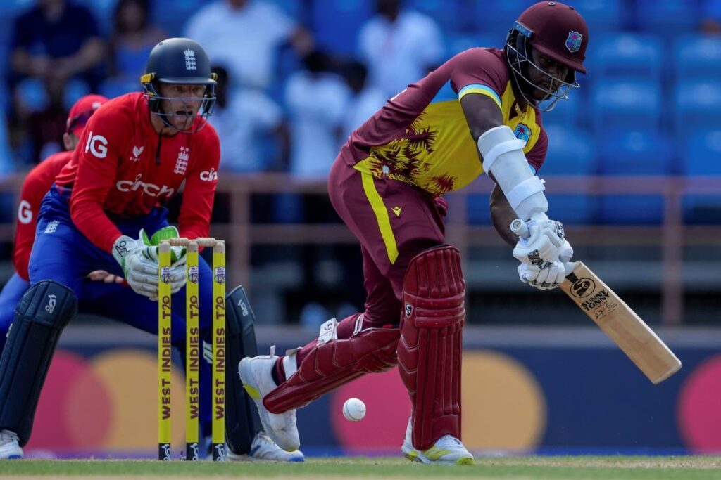 West Indies' Kyle Mayers plays a shot under the watch of England's captain Jos Buttler during the second T20 at National Cricket Stadium in Grenada, Thursday. - AP