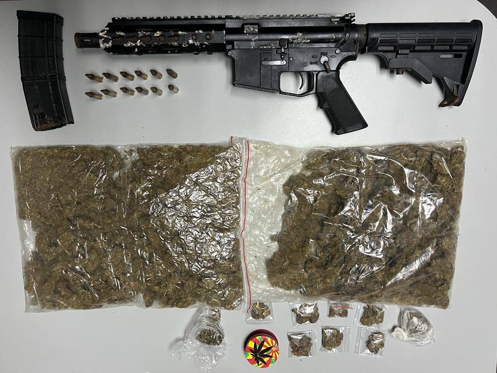 An AR-15 rifle, ammunition and marijuana seized by police on Friday during a raid at Calcutta #2, Freeport. Six foreign nationals were held in connection with the illegal items.  - Photo courtesy TTPS