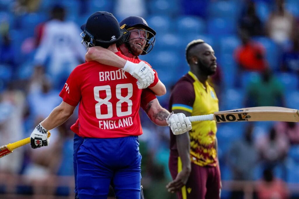 England's Harry Brook celebrates with teammate Phil Salt after hitting a six to defeat West Indies in the third T20 match at National Cricket Stadium in Saint George's, Grenada, Saturday. - Photo courtesy AP