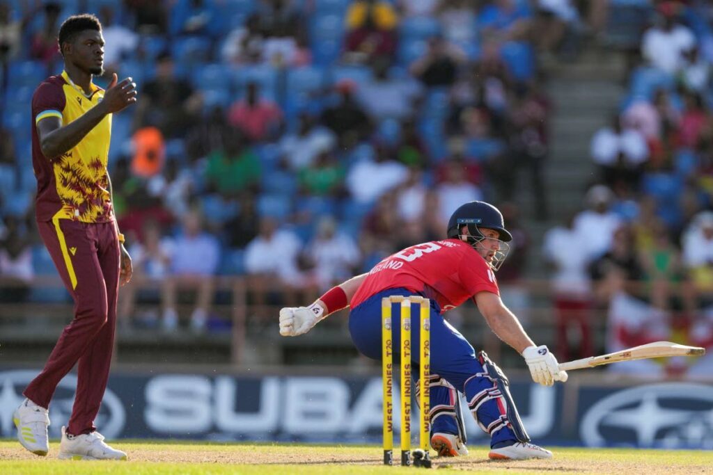England's Liam Livingstone scores runs from the bowling of West Indies' Alzarri Joseph, left, during the third T20 match at National Cricket Stadium in Saint George's, Grenada, Saturday. - AP