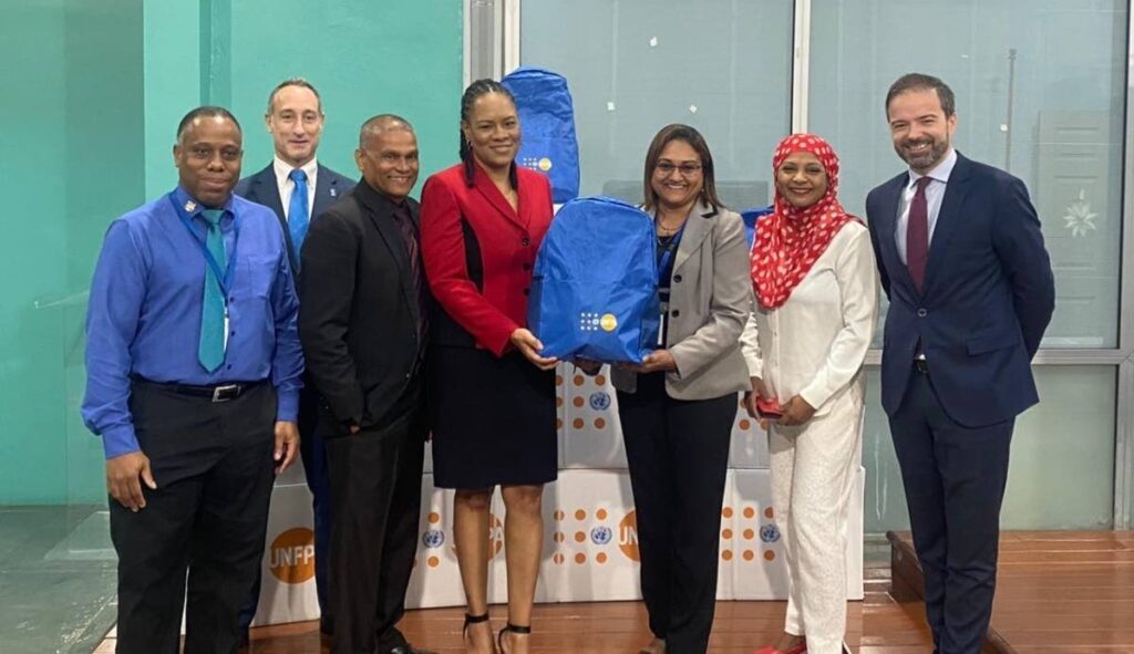 From left: UNDP programme assistant Lyndon Wright, UNDP resident representative Ugo Blanco, OPM Gender and Child Affairs Division acting permanent secretary Vijay Gangapersad, Minister in the OPM Ayanna Webster-Roy, UNFPA TT Liaison Office programme assistant Ellenmae Sobion, UNDP assistant resident representative Sharifa Ali-Abdullah and a fellow executive of UNDP at a formal handover of donations from the UN agencies on Monday. PHOTO COURTESY OPM - 