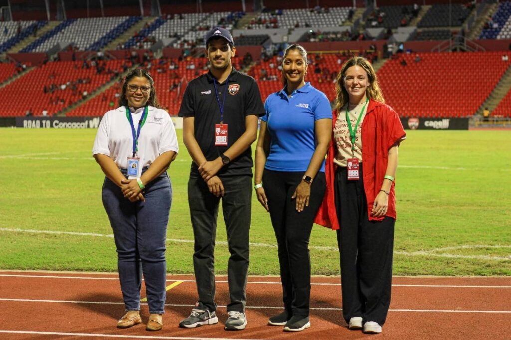 (L-R): Communications analyst of UN Women MCO Caribbean Shelly Dolabaille, TTFA general secretary Amiel Mohammed, planning and co-ordination specialist at the UN Je’nille Maraj and programme associate Leah O’Reilly.

Amiel Mohammed, General Secretary – TTFA is joined by UN Women MCO Caribbean staff before the game. L-R Shelly Dolabaille - Communications Analyst, Je’nille Maraj - Planning and Coordination Specialist, and Leah O’Reilly - Programme Associate - 