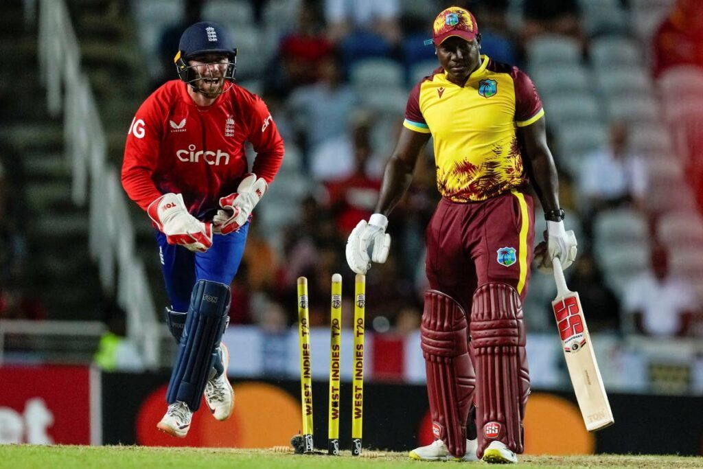 England's wicket keeper Phil Salt celebrates the dismissal of West Indies' captain Rovman Powell (R) during the fourth T20 at the Brian Lara Cricket Academy, in Tarouba, on Tuesday. - AP PHOTO