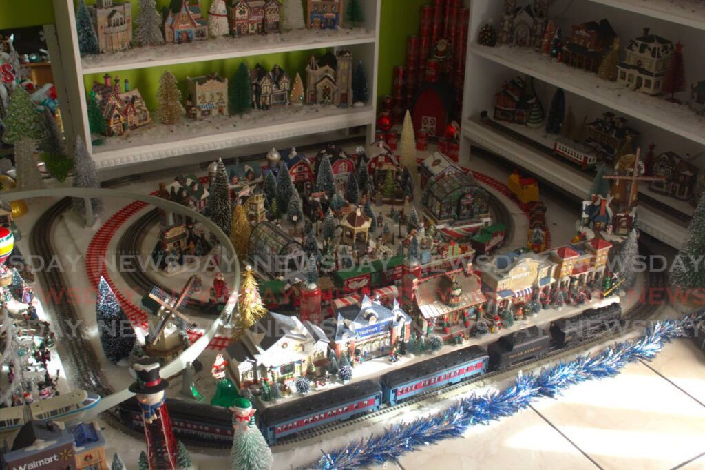 Dexter Kalloo's Christmas village surrounded by the model trains. - Photo by Sydney Joseph