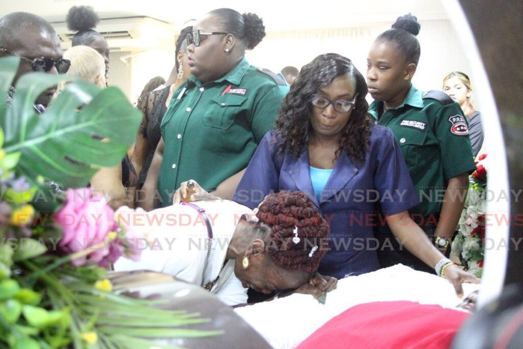 Sharon Wickham cries openly for her close friend Hollice Thomas and her son Noel Thomas who were stabbed to death at their Marabella home last Tuesday. The funeral for both was held at Belgroves Funeral Home, Coffee Street, San Fernando on Friday. - Lincoln Holder 