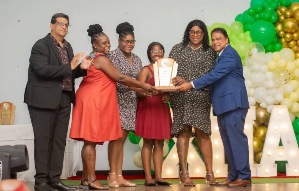 MP for Mayaro Rushton Paray, left, with members of the Omalo family and Dr Roodal Moonilal deputy political leader of the UNC at the  United National Congress (UNC) Mayaro Christmas Dinner and Awards Ceremony. - 