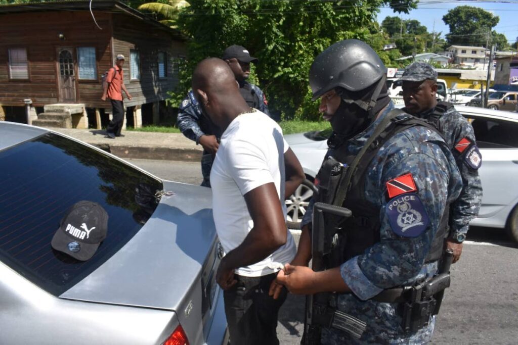 Police officers stop and search a driver during an anti-gang operation in Tobago on Saturday.  - Photo courtesy TTPS