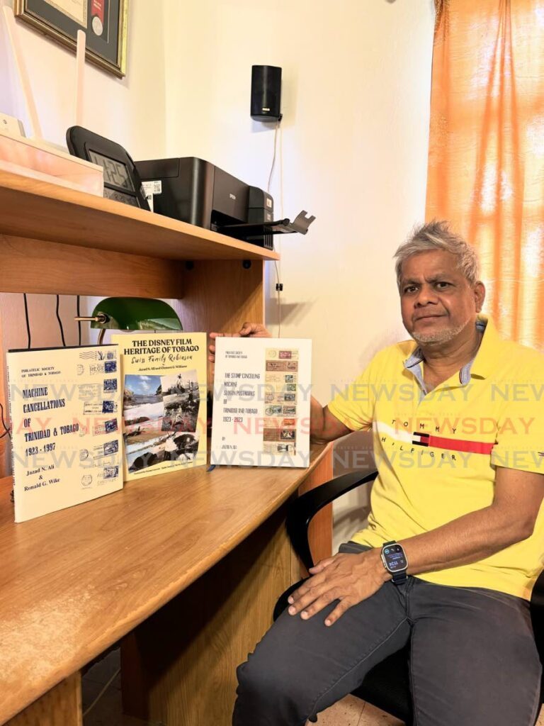 Author Jazad N Ali with his three books, Machine Cancellations of Trinidad & Tobago 1923-1997, The Disney Film Heritage of Tobago, Swiss Family Robinson and The Stamp Cancelling Machine Slogan Postmarks of Trinidad and Tobago 1923 – 2023. Tobago, Swiss Family Robinson and The Stamp Cancelling Machine Slogan Postmarks of Trinidad and Tobago 1923 – 2023. - Photo courtesy Jazad N Ali