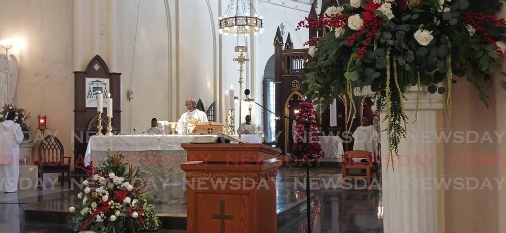 Vicar General Martin Sirju officiating at Christmas mass at the Cathedral of the Immaculate Conception in Port of Spain on Monday. PHOTO BY JOEY BARTLETT - Joey Bartlett