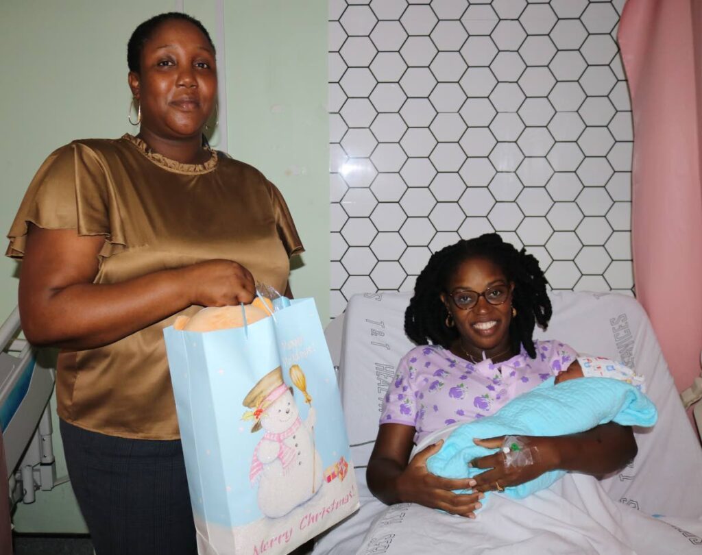 Hospital administration manager Keisha Pritchard gives Sacha Marshall a bag filled with baby products. 
   - Courtesy ERHA 