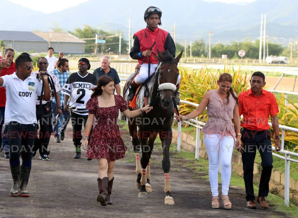 Hello World and jockey Brian Boodramsingh soak in the applause after winning the Edmund De Freitas Gold Cup on Boxing Day, at Santa Rosa Park, Arima. - ANGELO MARCELLE