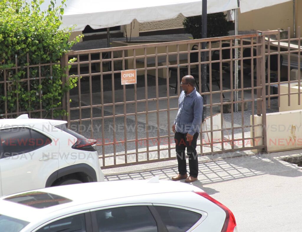 CLOSED: A man stands outside the National Insurance Board (NIB) offices on Harris Promenade, San Fernando on Tuesday after it was closed following a ransomeware attack. 
Photo by Lincoln Holder 