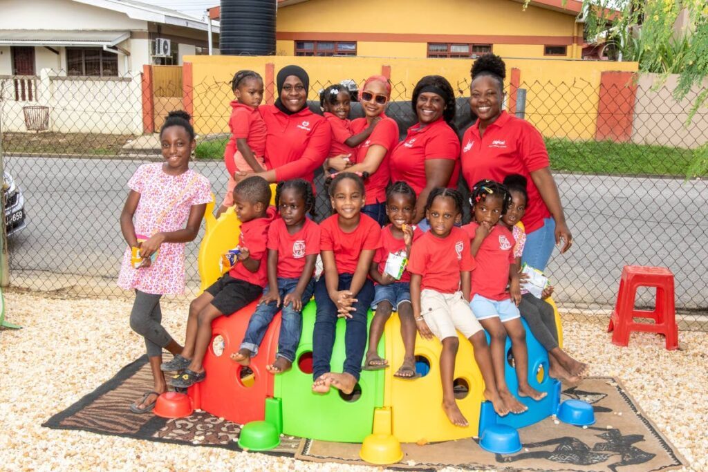 Bearing all smiles! Kids of Eden Academy preschool in Edinburgh 500 happily pose with a team of Digicel Retention Agents during their first playday at their newly enhanced outdoor play area courtesy the ‘Digi Christmas is D Bess’ Staff Initiative - Photo courtesy Digicel