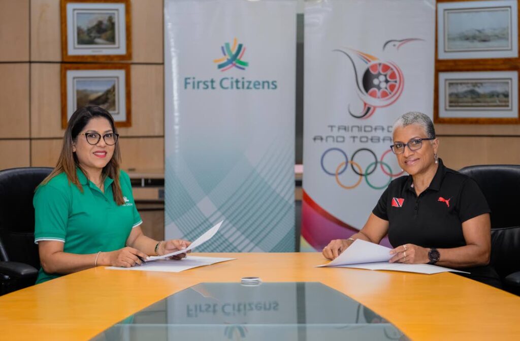 Neela Kissoon, group deputy CEO (designate) at First Citizens, left, and TTOC president Diane Henderson countersign an agreement in solidarity of First Citizens commitment to sport and community. - courtesy First Citizens
