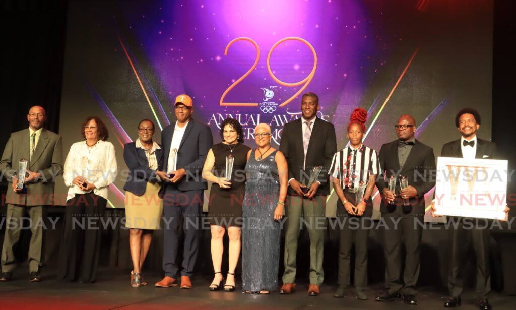 TTOC president Diane Henderson, fifth from right, with awardees at the TTOC awards function at Hyatt, Port of Spain on Friday. - ROGER JACOB