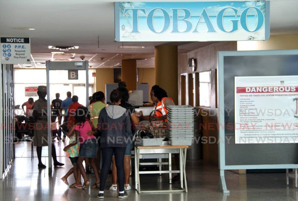 Passengers clear security at the Piarco International Airport as they head to the Tobago
departure lounge. - File photo