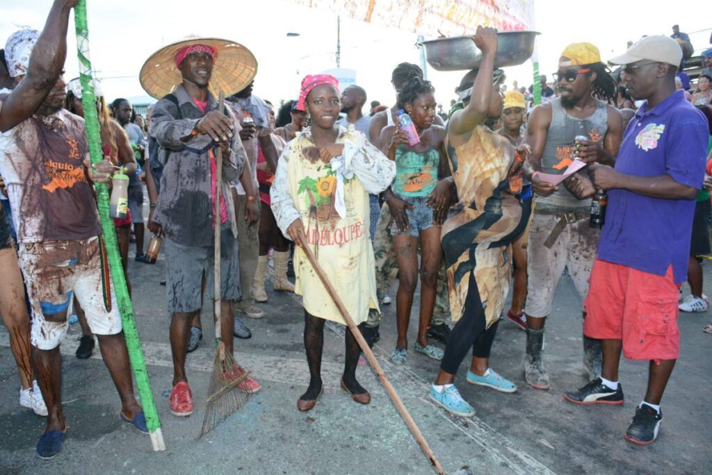 Masqueraders from the J'Ouvert band Cocoa Beans to Liquid enjoy themselves at Crown Point on  Carnival Monday. - Photo by Vindra Gopaul