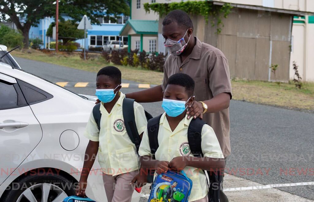 Two students arrive at the Signal Hill Government Primary School. - File photo 