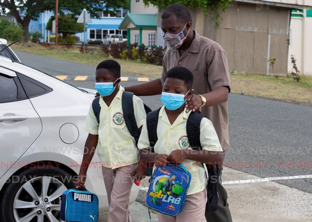 FLASHBACK: Two Signal Hill Government Primary School students wear their masks as they were dropped off to school in April, 2022. Covid mitigation protocols are set to be reintroduced in schools across the island following a sharp rise in cases of people showing covid/flu symptoms. File photo by David Reid 