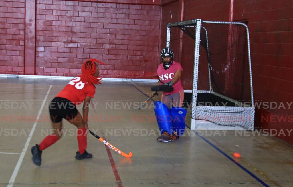 Paragon's Antoine Nurse has her shot blocked by Malvern's goalkeeper at the Woodbrook Youth Facility.  - File photo by Angelo Marcelle