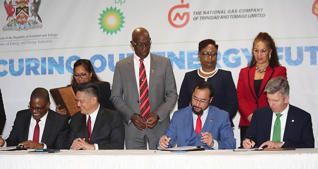Prime Minister Dr Keith Rowley, centre, overlooks the signing of the heads of agreement with ALNG shareholders on the restructuring of Atlantic LNG in 2022. FILE PHOTO - 