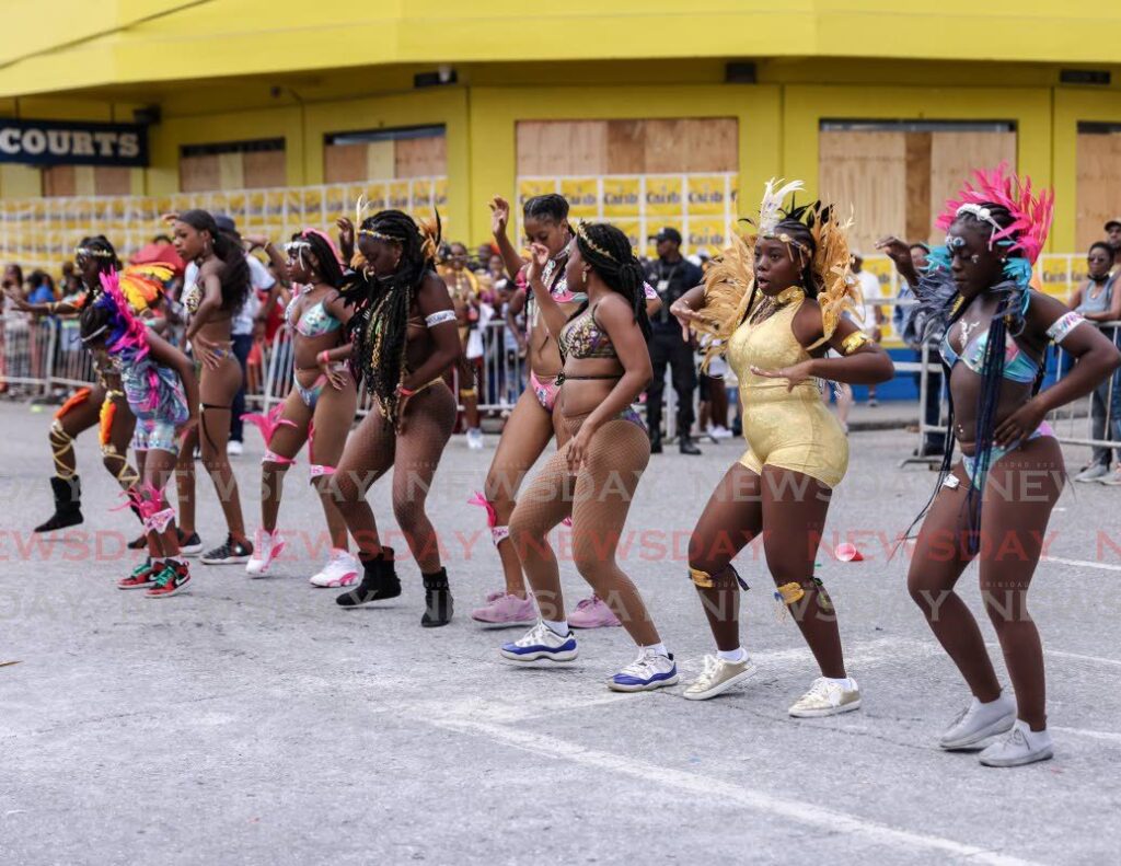 Revellers from Picton Folk Performing Company Vibezmas Carnival 2023 perform at the NCC Downtown judging point, South Quay, Port of Spain on February 21, 2023. Feet can bear the brunt of the Carnival festivities so it’s important to wear proper shoes. - Photo by Jeff K Mayers