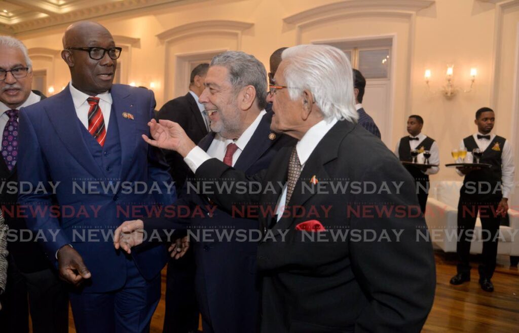 Former prime minister Basdeo Panday, right, points at Prime Minister Dr Keith Rowley, during a light moment with St Vincent PM Dr Ralph Gonsalves, centre, at a cocktail reception in honour of visiting Caricom heads at President's House, St Ann's, in July last year. - Photo by Anisto Alves 