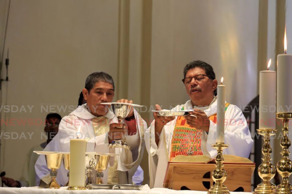 Archbishop Charles Jason Gordon, right, leads the New Year's Day mass held at The Cathedral of the Immaculate Conception, Port of Spain, on Monday morning, - ROGER JACOB