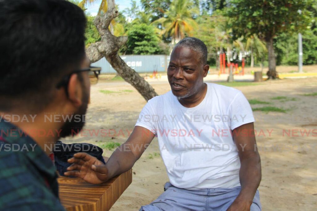 Rory Henry, right, speaks to Newsday reporter Rishard Khan about crime in Trinidad and Tobago at 
Vessigny Beach on Monday. - Photo by Lincoln Holder 