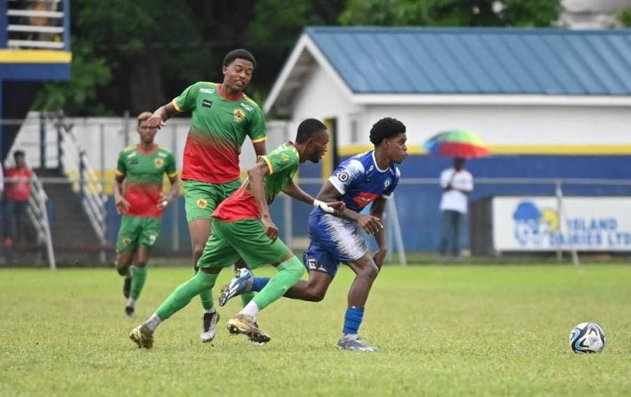Nathaniel James of Mt Pleasant FC, right, dribbles past two players from Humble Lion FC during a Jamaica Premier League match on Sunday. - courtesy Mt Pleasant Football Academy Facebook page