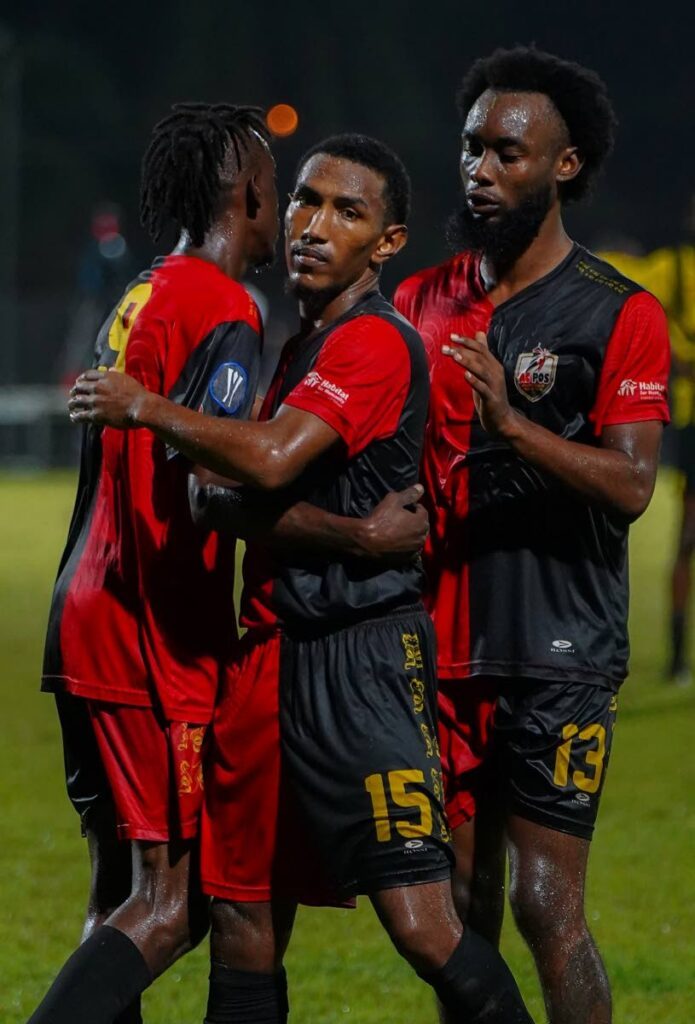 AC Port of Spain's John-Paul Roshford (C) is congratulated by teammates after scoring against Central FC during a TT Premier League match on December 20 at the Diego Martin Sporting Complex. - TT Premier League