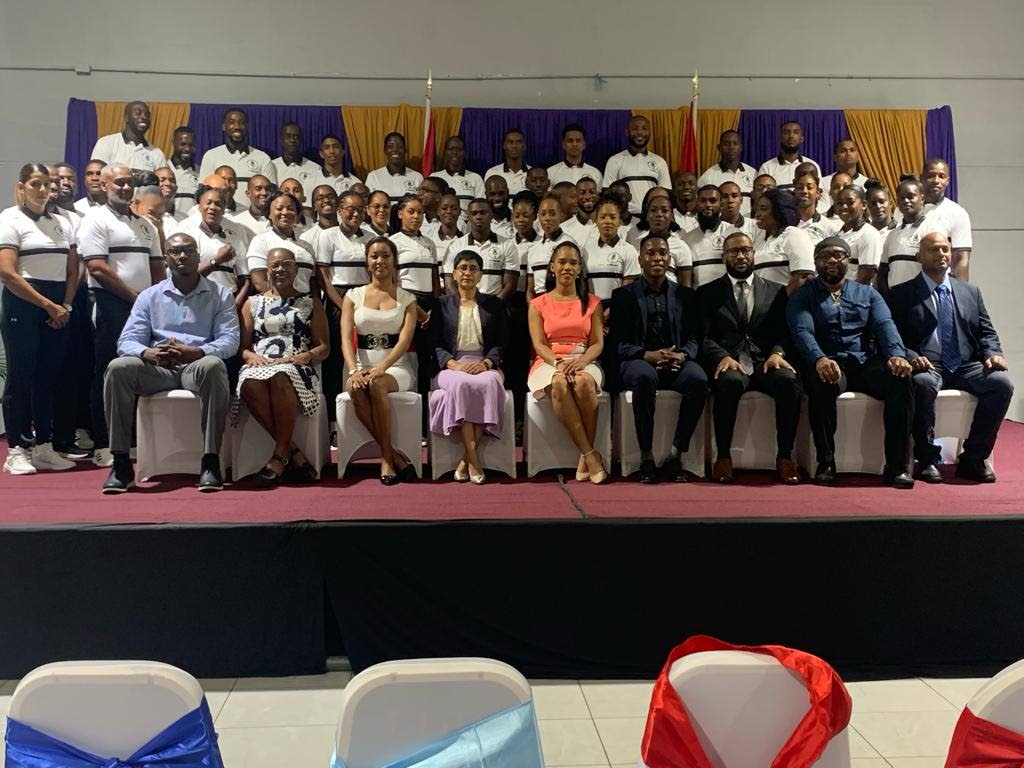 Staff of UTT's Centre for Kinesiology Physical Education and Sport with physical training instructor graduates at a graduation ceremony, last month. - 