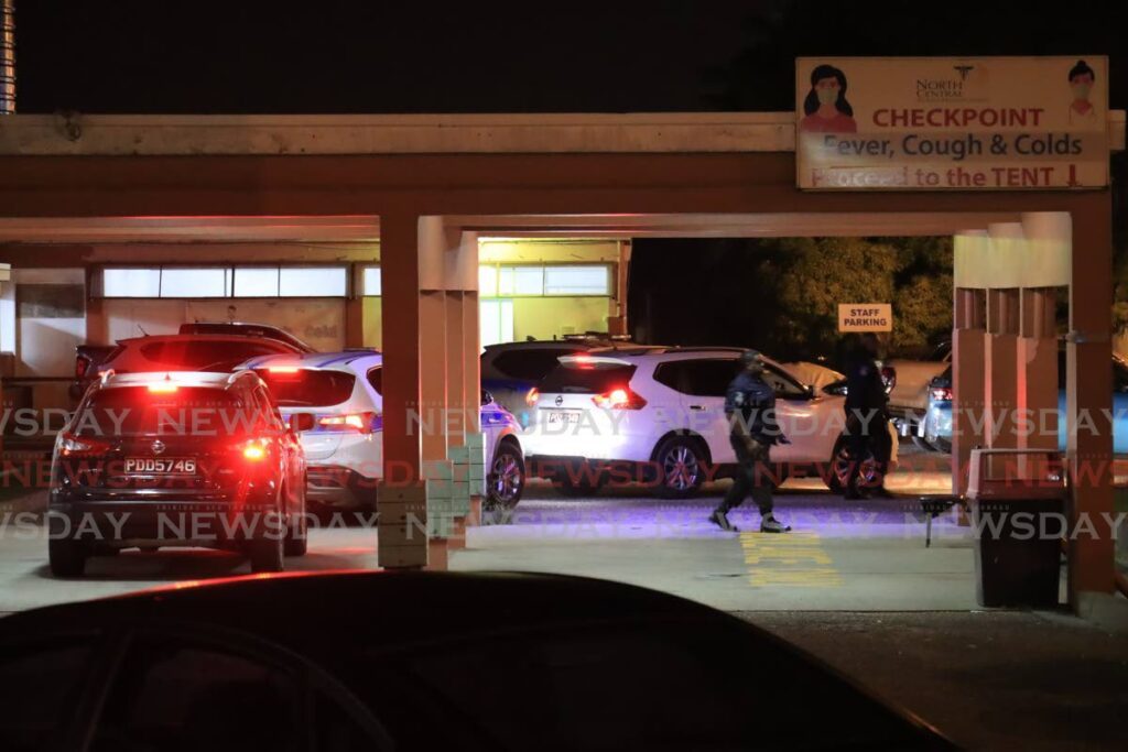 The suspect wanted by police in connection with the double homicide on Tuesday morning in Glencoe, has been captured by police, seen in the photo the heavy police presence when the  suspect was then taken to the Accident and Emergency at the Arima Hospital for medical  treatment, he was then transported under heavy police protection to an undisclosed police station as investigations continue by homicide investigators. - Photo by Roger Jacob 