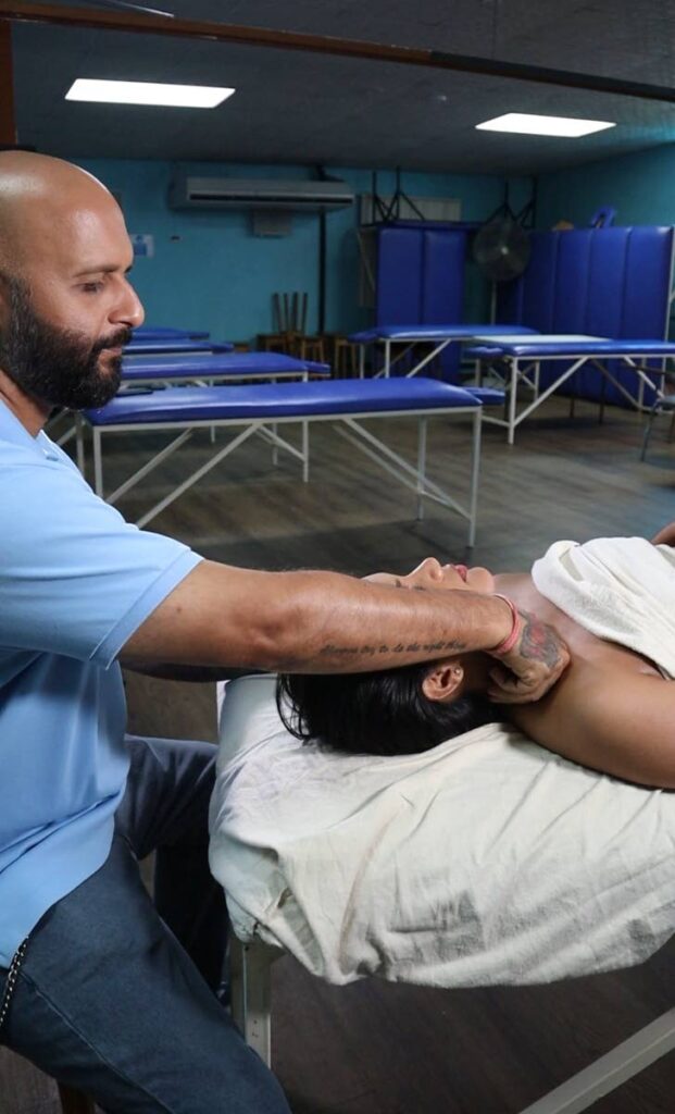Pravin Gopaul gives his client a relaxing shoulder massage at his institution.  - 