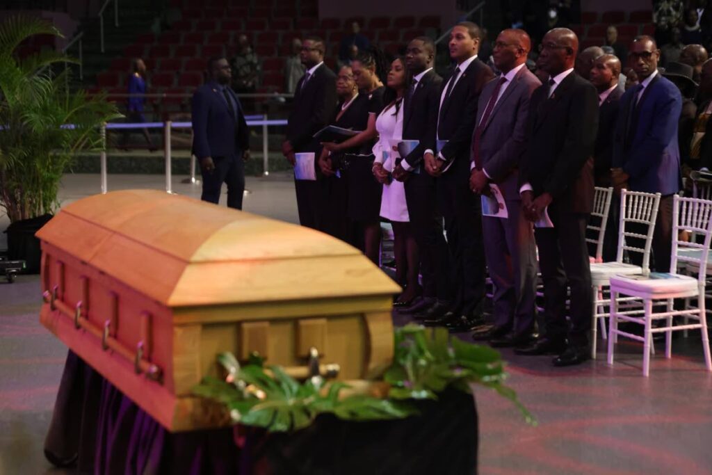 VIPs includinig the Prime Minister and the Chief Justice stand not too far from the coffin of former THA chief secretary Hochoy Charles during his funeral on Thursday at the Shaw Park Complex in Tobago.