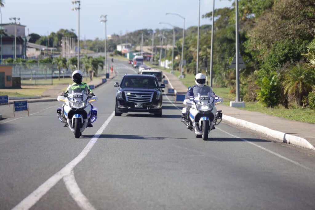 Police escort the hearse with the remains of former chief secretary Hochoy Charles en route to the church for his funeral on Thursday.
