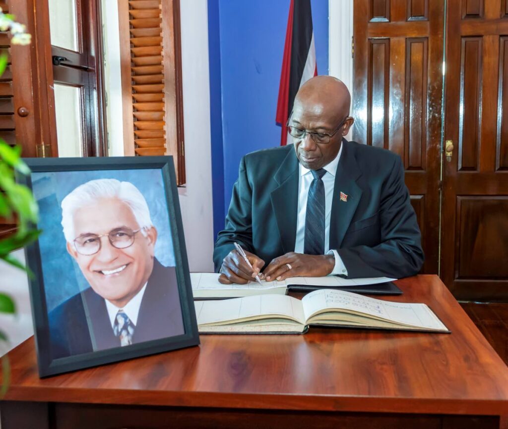 The Prime Minister signs the condolence book on Thursday at the Assembly Legislature Building in Scarborough, Tobago opened in honour of former prime minister Basdeo Panday, who died on Monday. -Photo courtesy Assembly Legislature