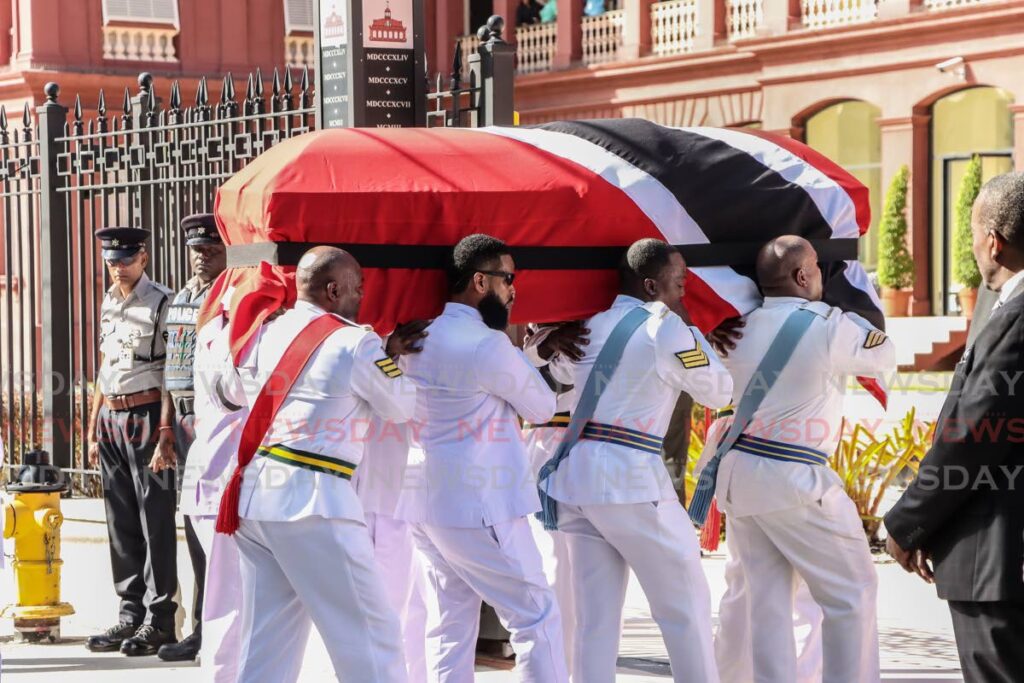 Members of the Defence Force carry the body of former prime minister Basdeo into the Red House on January 5. - Photo by Faith Ayoung