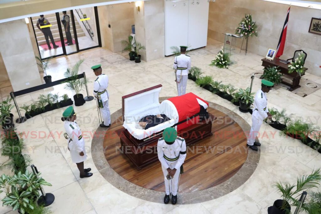 A military honour guard surrounds the body of former prime minister Basdeo Panday as he lies in state at the Red House Rotunday, Port of Spain, on Friday. - Photo by Faith Ayoung