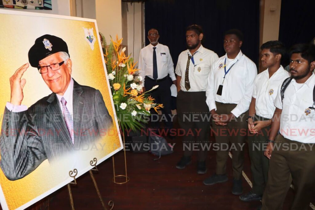 Presentation College students look at a photo of former prime minister and past student Basdeo Panday, at a rememberance service held in his honour at the San Fernando school on January 4. - Photo by Angelo Marcelle