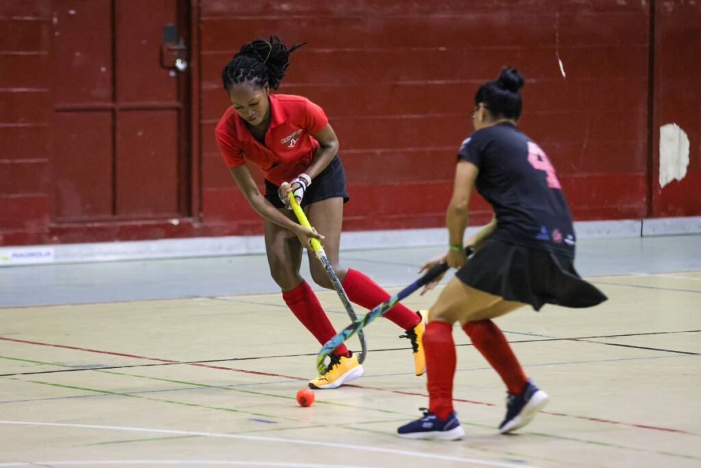 Paragon’s Gabrielle Thompson (L) begins an attack against Old Fort Women’s Bushanie Kaladeen during the Ventures Indoor Hockey International Invitational Tournament men’s match at the Woodbrook Youth Facility in Port of Spain, on Thursday. Paragon Women won 4-0. - Photo by Daniel Prentice