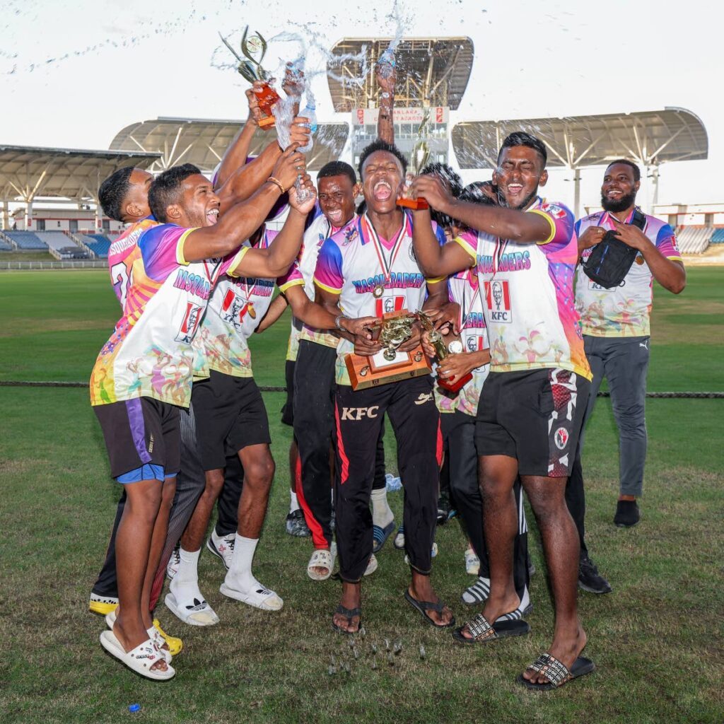 North/ Tobago Masqueraders celebrate with the champions' trophy after beating Central/ South West Flamingos by one wicket in the final of the TT Cricket Board's Under-23 Cup tournament.  - DANIEL PRENTICE