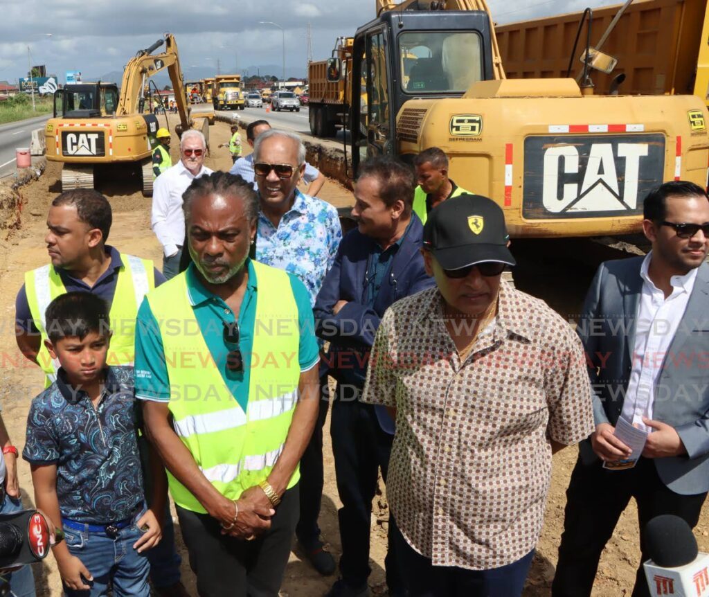 Minister of Works and Transport Rohan Sinanan, second from right,  PURE director Hayden Phillips, centre, contractor Junior Sammy, behind Phillip, and other officials at the construction site for the addition of lanes to the Solomon Hochoy Highway in Chaguanas, on Sunday. - Angelo Marcelle