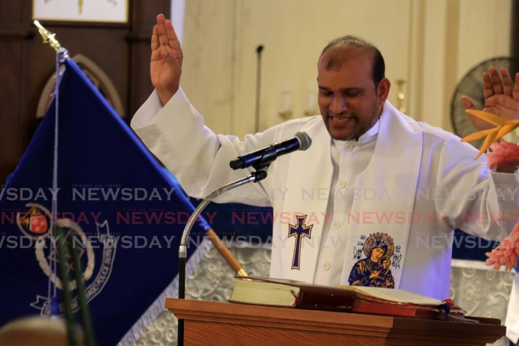 Father David Khan gives his sermon at the police's annual interfaith service at the Cathedral of the Immaculate Conception, Port of Spain, on Sunday. - Photo by Roger jacob