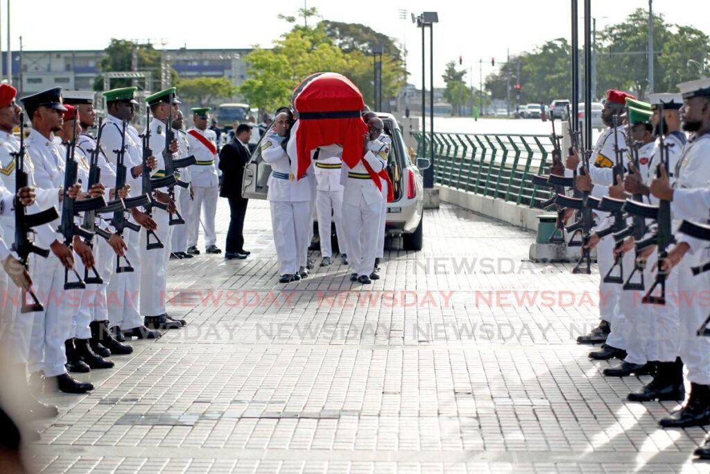 Military pallbearers carry the body of the late prime minister Basdeo Panday to the Southern Academy for the Performing Arts, San Fernando where his body lay in state on Monday.  - Lincoln Holder 