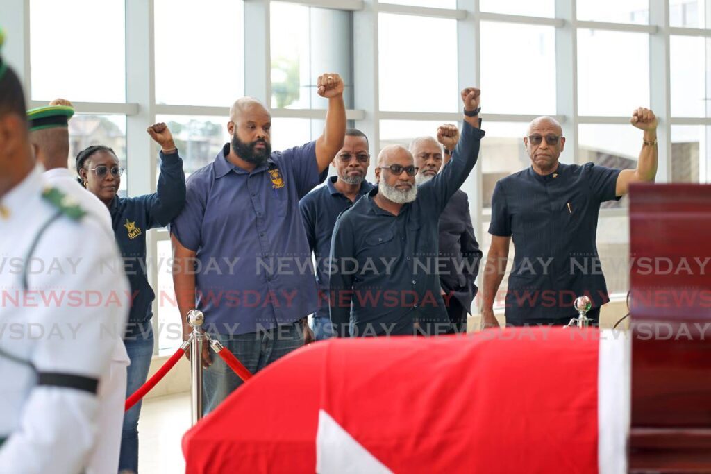 JTUM president general Ancel Roget, at right, and union members raise their fists in salute to the late Basdeo Panday as the former prime minister and labour leader's body lay in state at the Southern Academy for the Performing Arts in San Fernando on January 8 - Lincoln Holder 